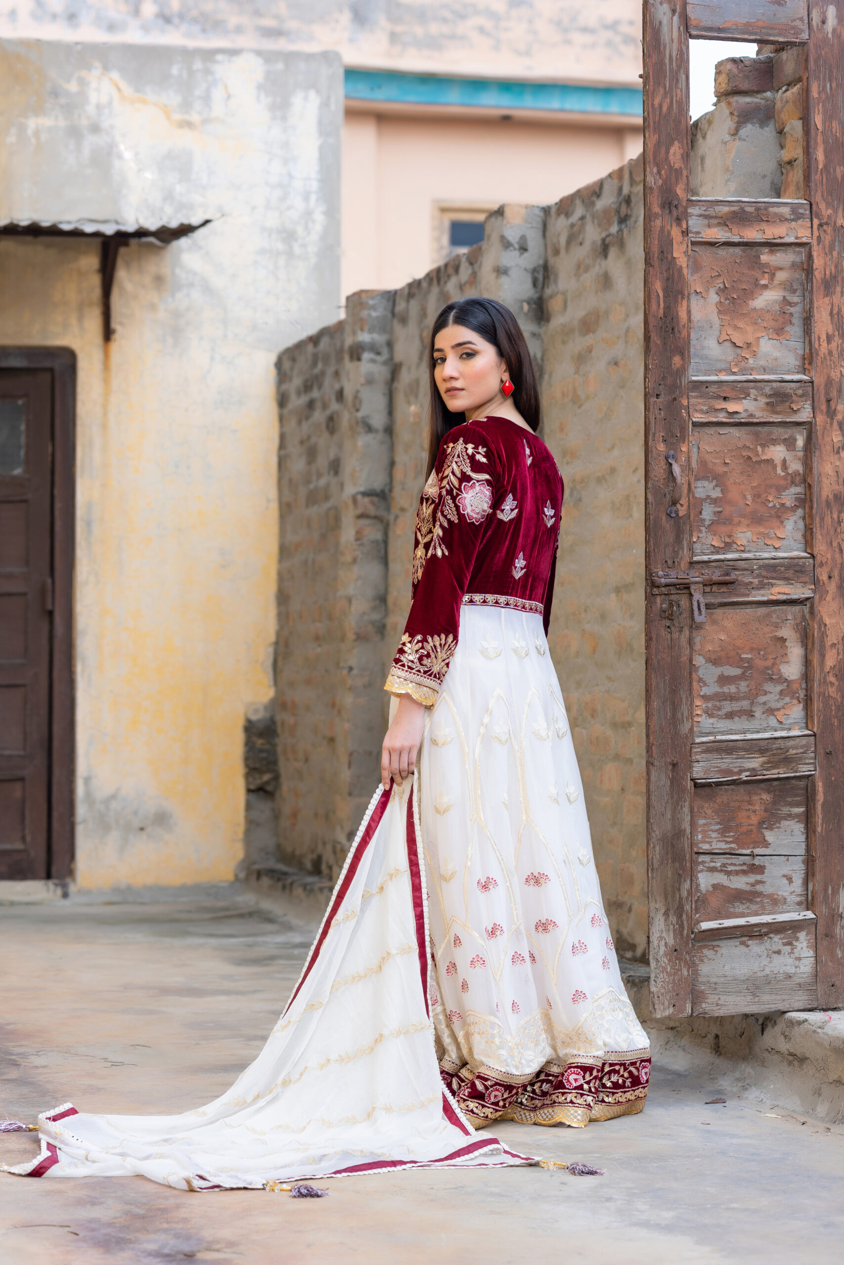 Luxurious embroidered velvet and chiffon frock in maroon and off-white with raw silk trousers and chiffon dupatta.