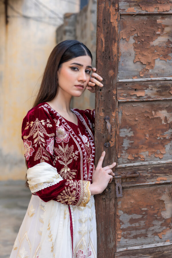 Luxurious embroidered velvet and chiffon frock in maroon and off-white with raw silk trousers and chiffon dupatta.